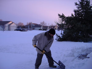 Man Shoveling Snow - snow removal idaho falls